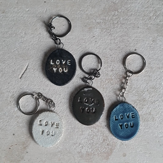 handcrafted oval ceramic key rings with embossed words LOVE YOU