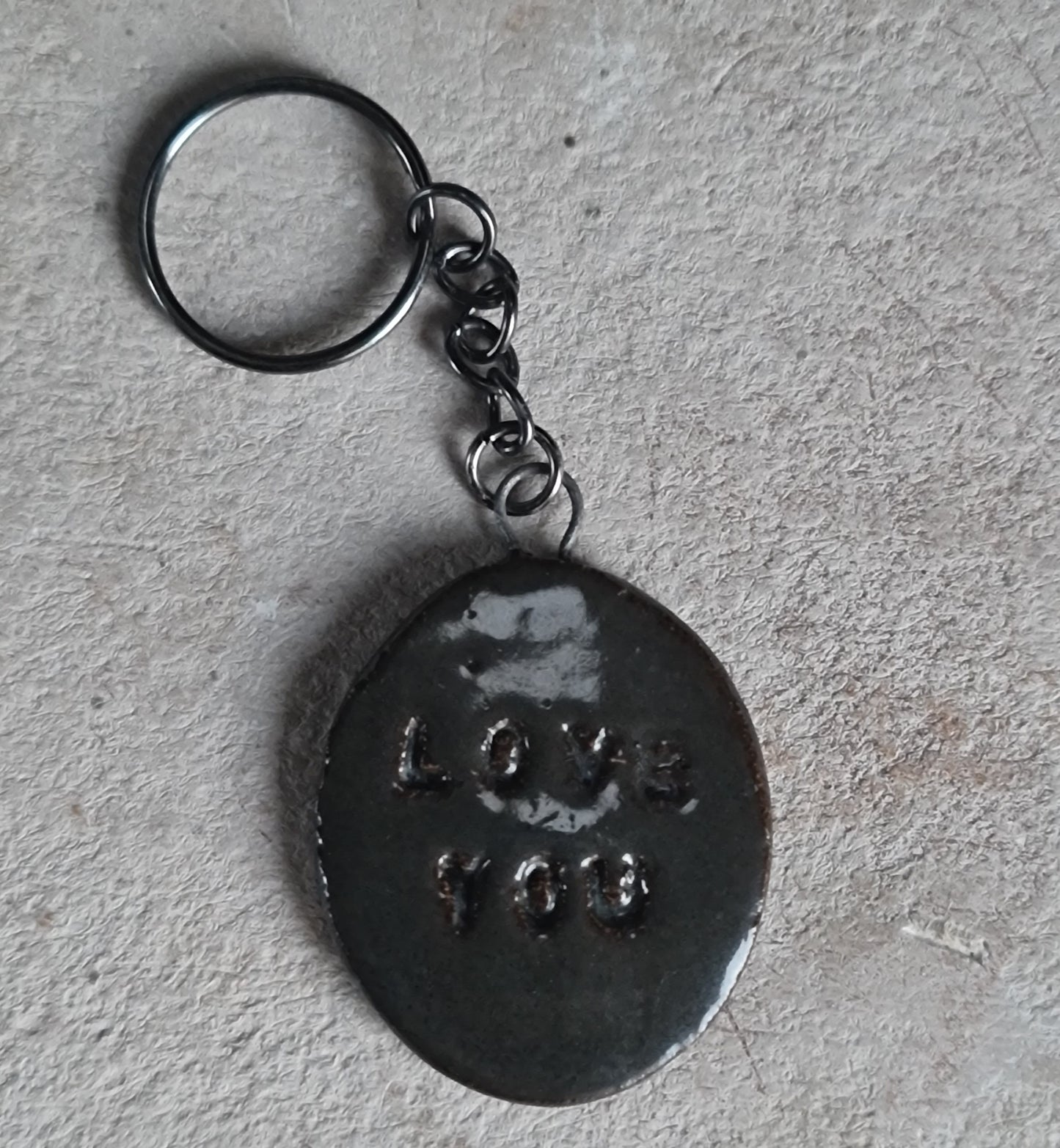 handcrafted oval ceramic key rings with embossed words LOVE YOU