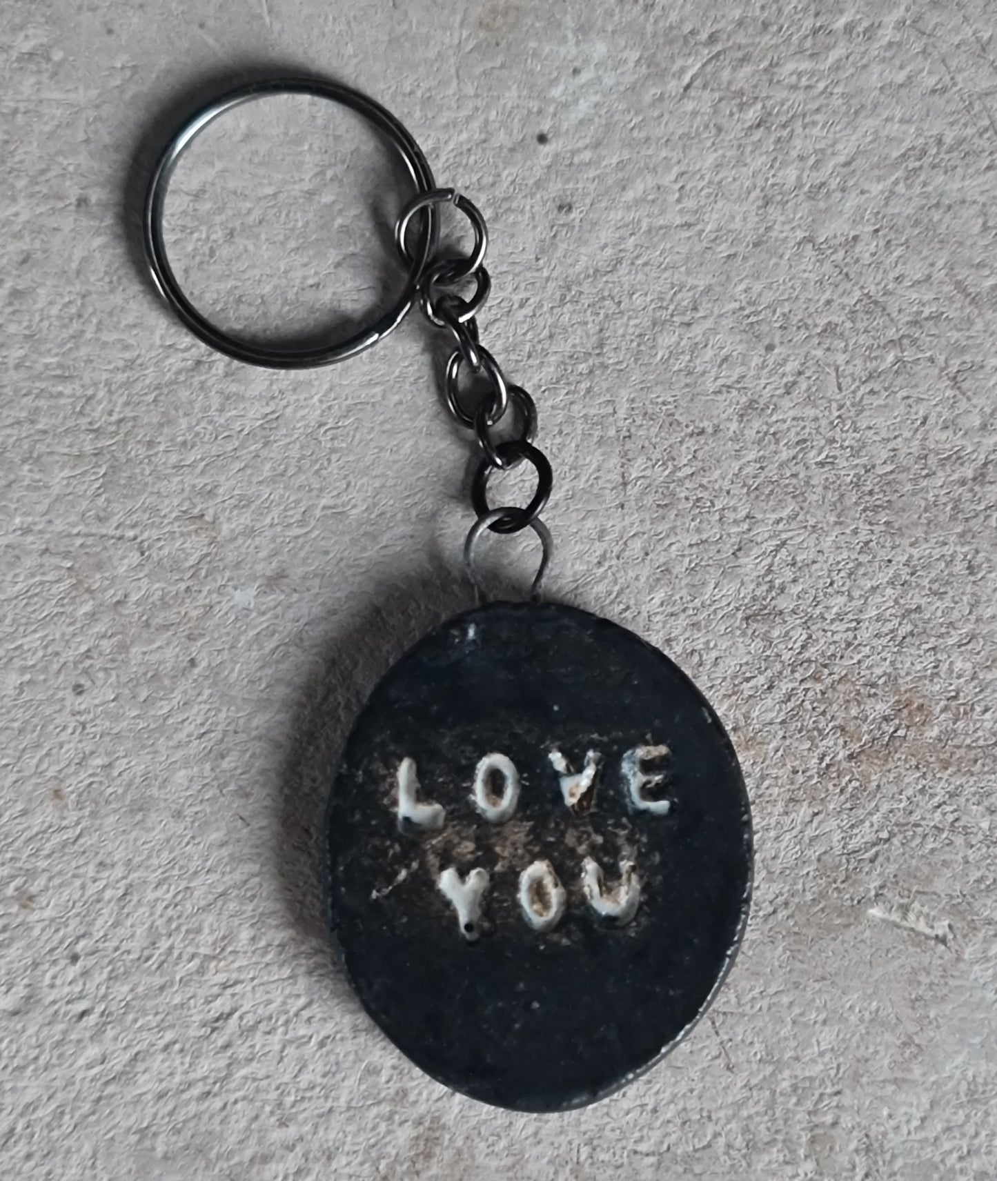 handcrafted oval ceramic key rings with embossed words LOVE YOU