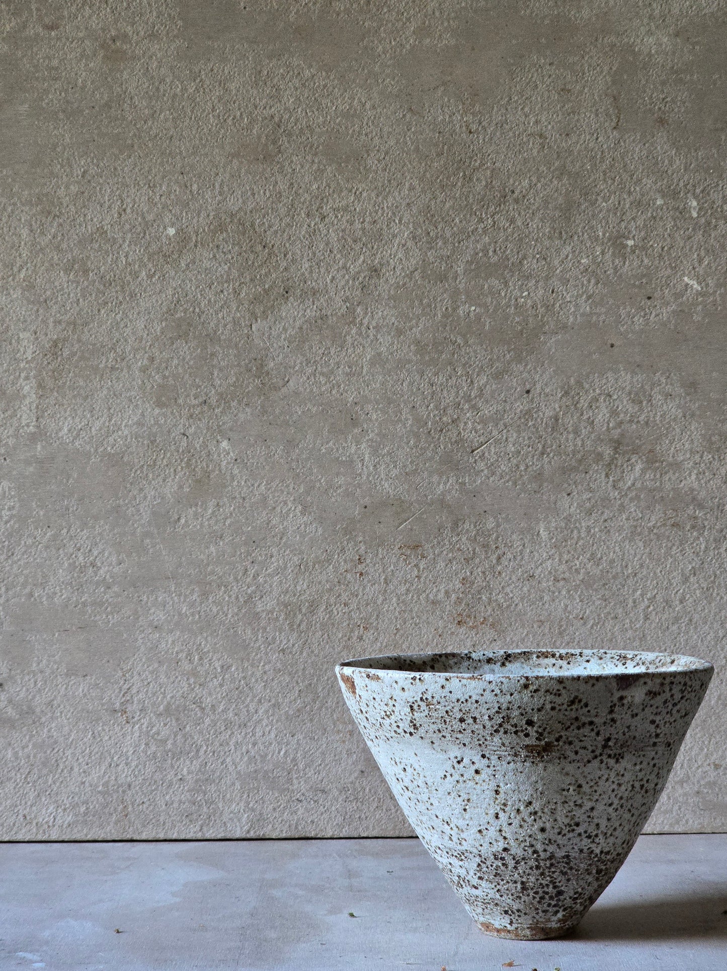 speckled white conical vessel/vase