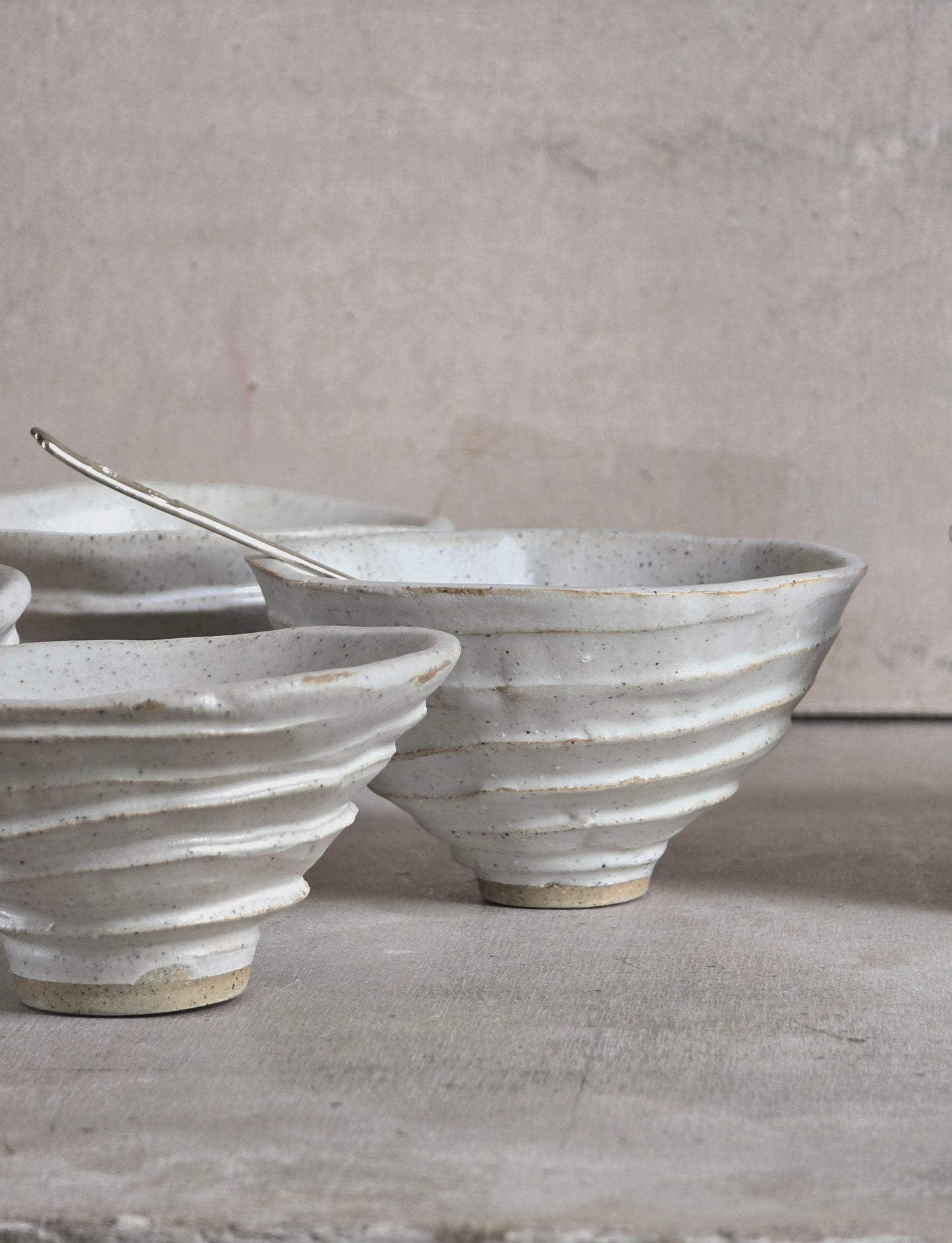 organically shaped creamy white bowls and a squarish shape vessel