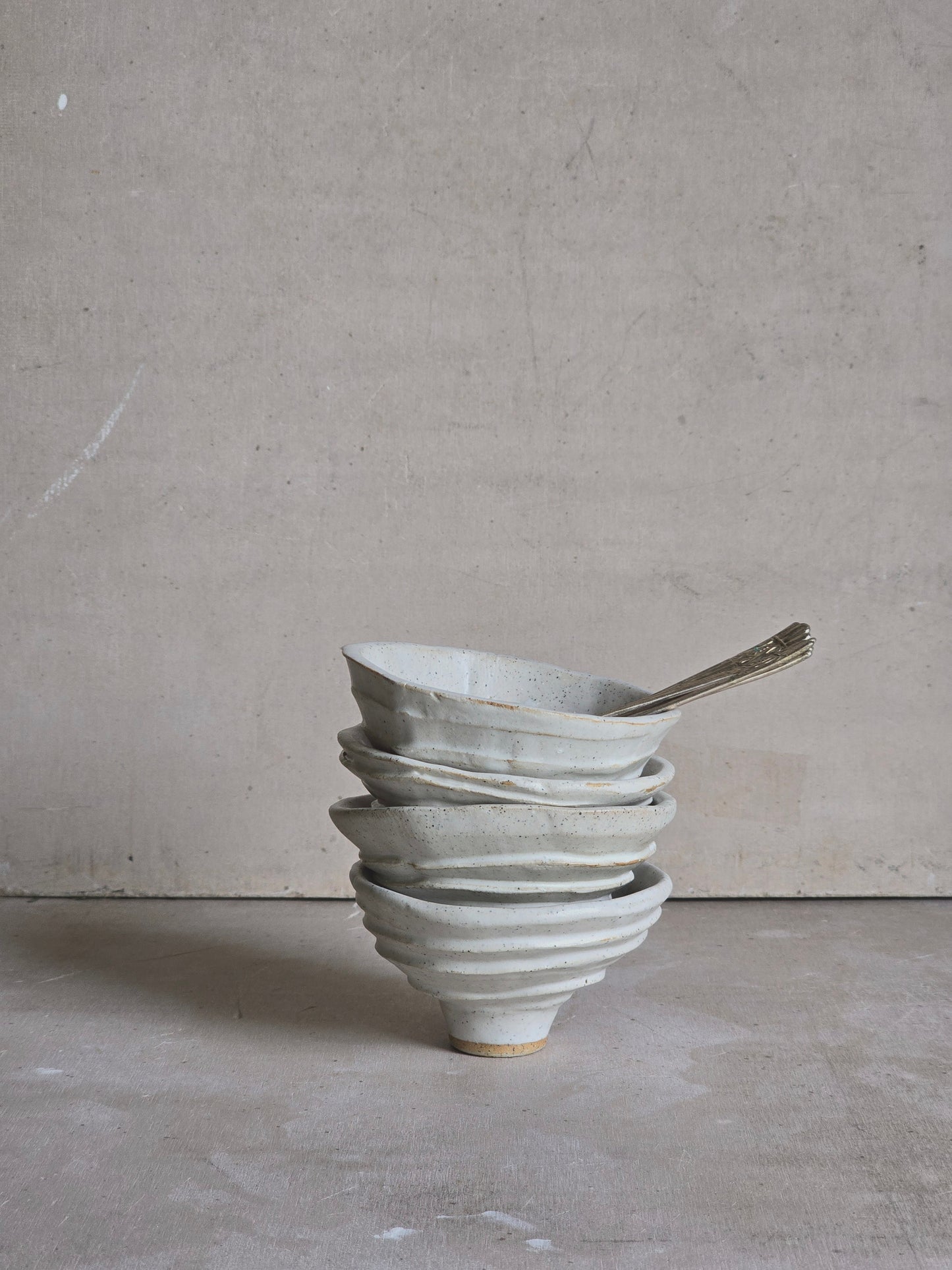 organically shaped creamy white bowls and a squarish shape vessel