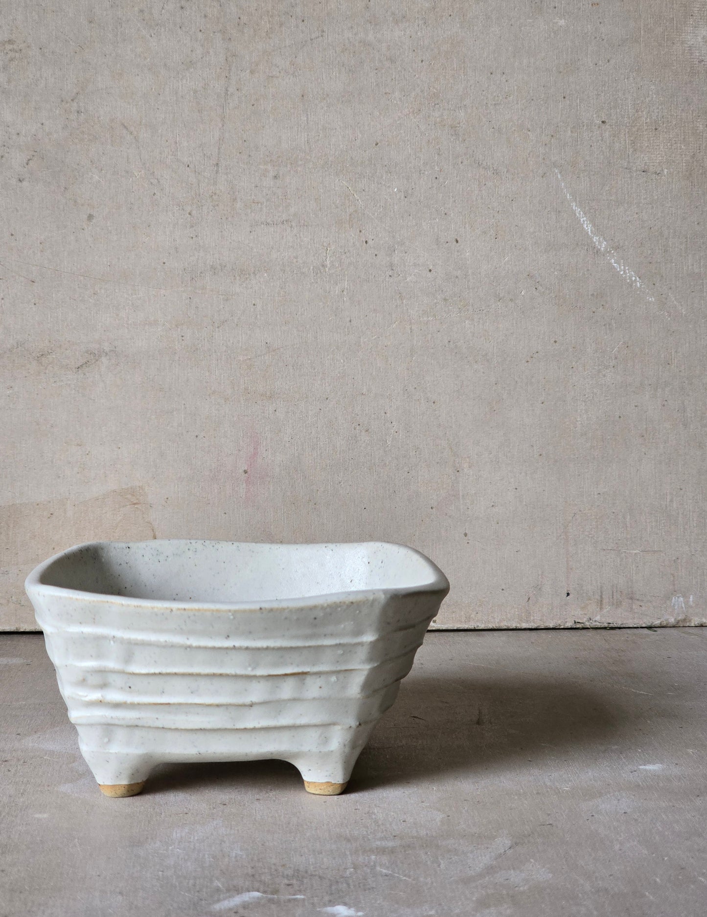 organically shaped creamy white bowls and a squarish shape vessel